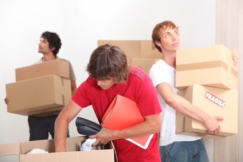Local removal team handling boxes and furniture for a Dalston move